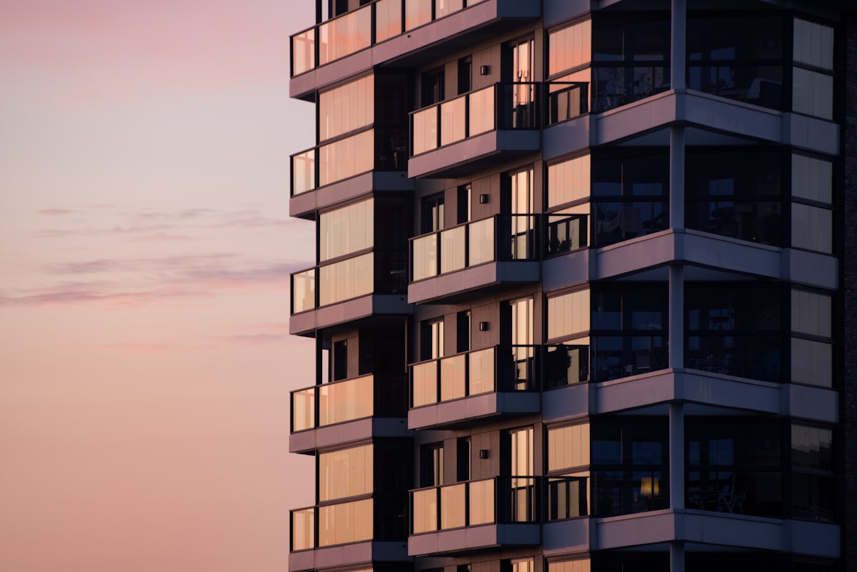 Modern white concrete residential tower during daytime